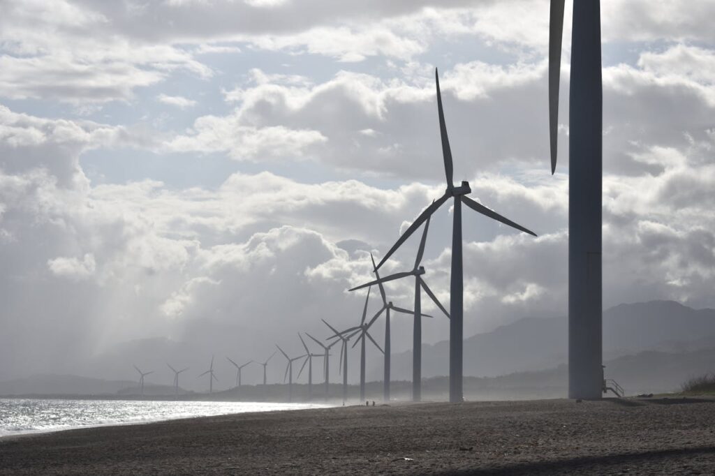 Windmills on Seashore Under White Clouds